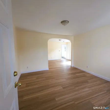 a view of a room with wooden floor