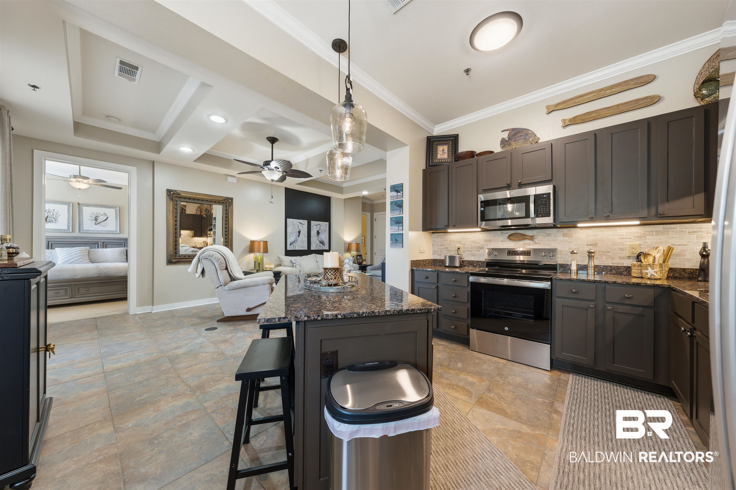 1430 Regency Road, Unit H202 Gulf Shores, AL 36542 - Photo 25 of 25 Kitchen featuring stainless steel appliances, dark stone countertops, open floor plan, a breakfast bar, and pendant lighting