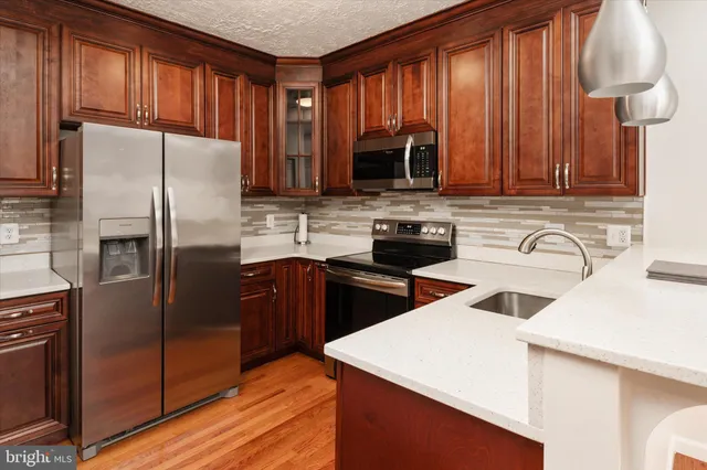 a kitchen with a sink stove and microwave
