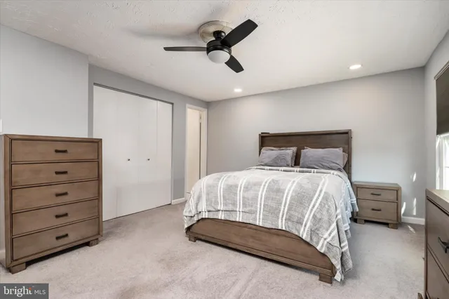 a bedroom with a bed and a painting on the wall