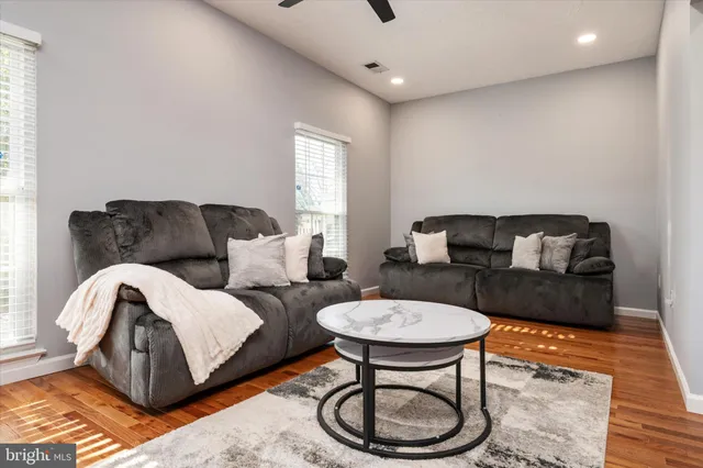 a living room with furniture a rug and a window