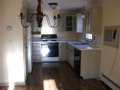 1 18th Street South, Unit 12 Edgartown, MA 02539 - Photo 3 of 5 a kitchen with a stove a sink and a refrigerator