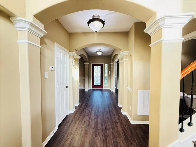 a view of a hallway with wooden floor
