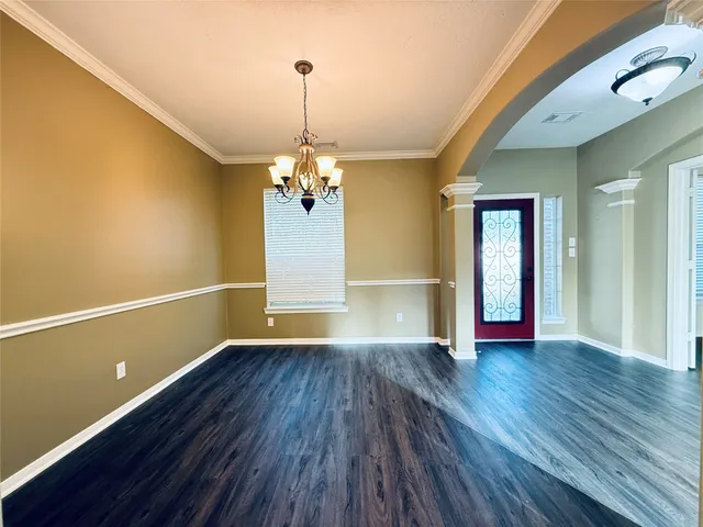 a view of empty room with wooden floor and stove