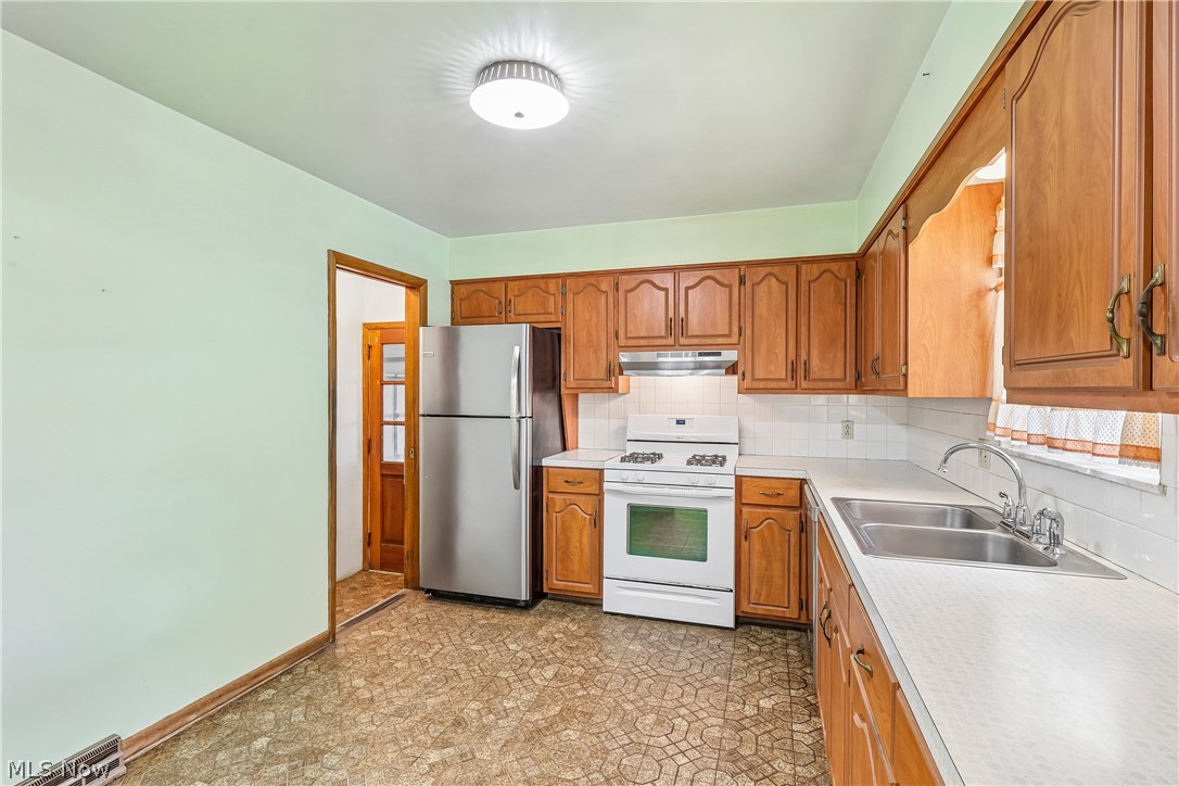 2758 Shellhart Road Norton, OH 44203 - Photo 9 of 41 Kitchen with sink, cabinets, dishwasher, stove, refrigerator and tile flooring