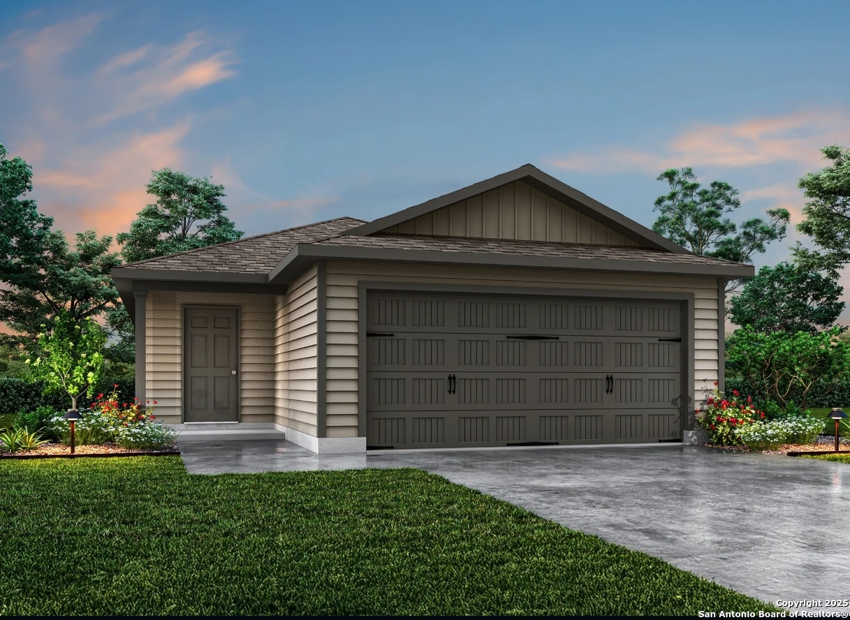 503 Sendera Way Kenedy, TX 78119 - Photo 2 of 5 a front view of a house with a yard and garage