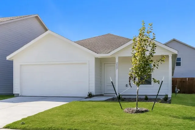 a backyard of a house with table and chairs