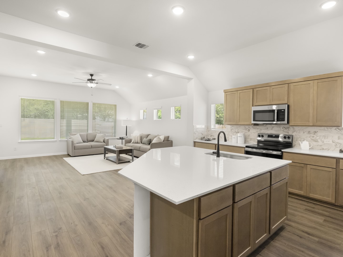 402 Judson Street Bertram, TX 78605 - Photo 5 of 27 a kitchen with sink a microwave and cabinets