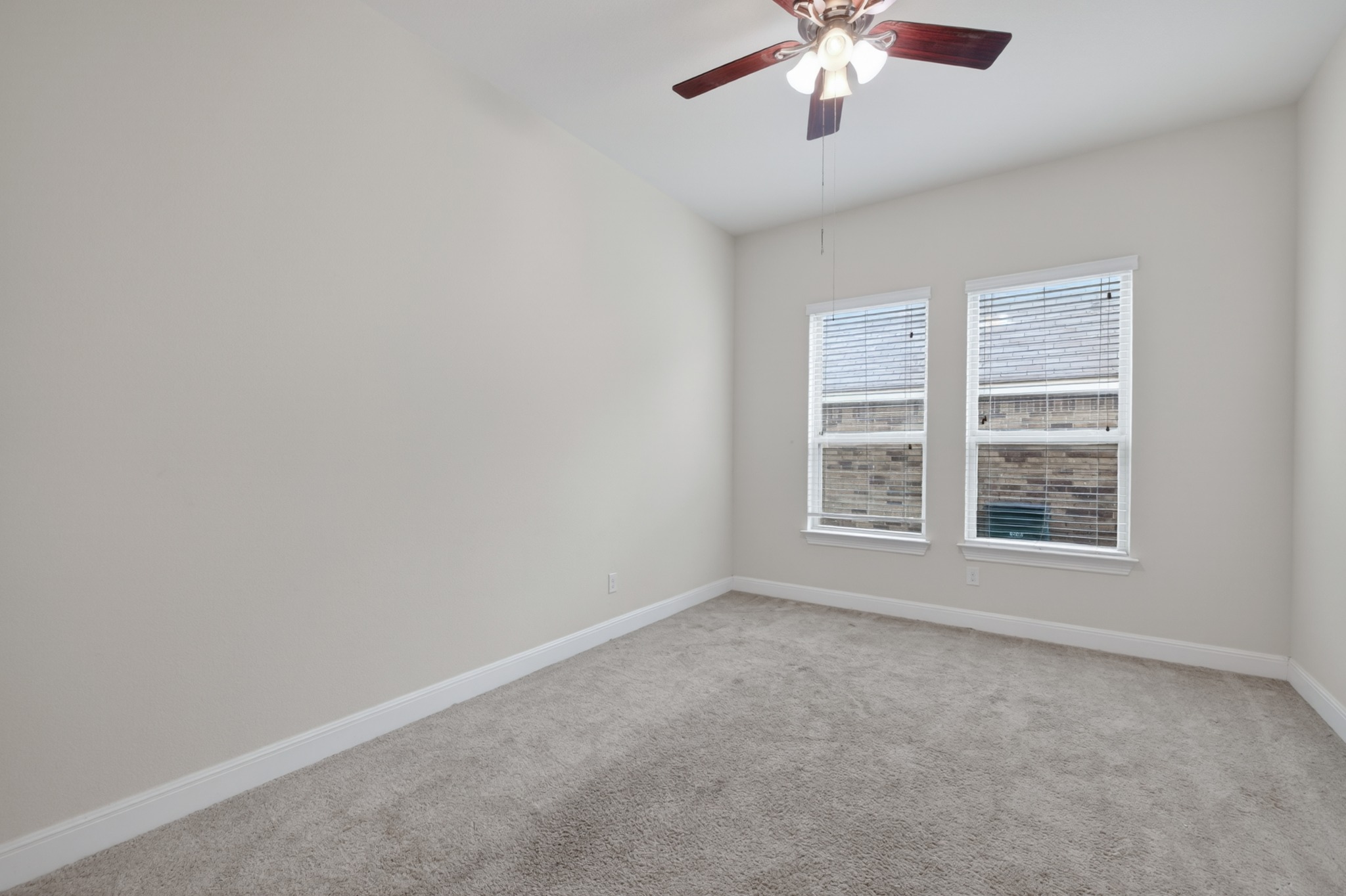 1017 Tabernash Leander, TX 78641 - Photo 28 of 38 Carpeted room featuring dual windows with blinds and a ceiling fan with light fixture