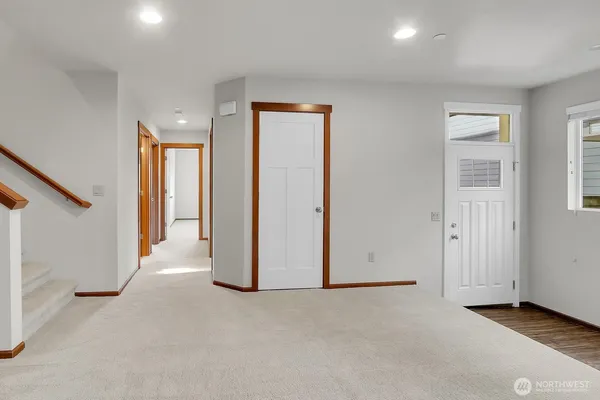wooden floor in an empty room with a staircase