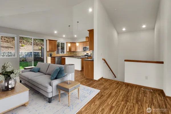 a living room with furniture and a wooden floor