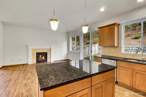 a kitchen with stainless steel appliances granite countertop a sink a oven and a counter space