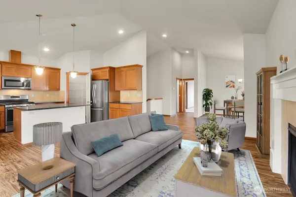 a living room with furniture and kitchen view