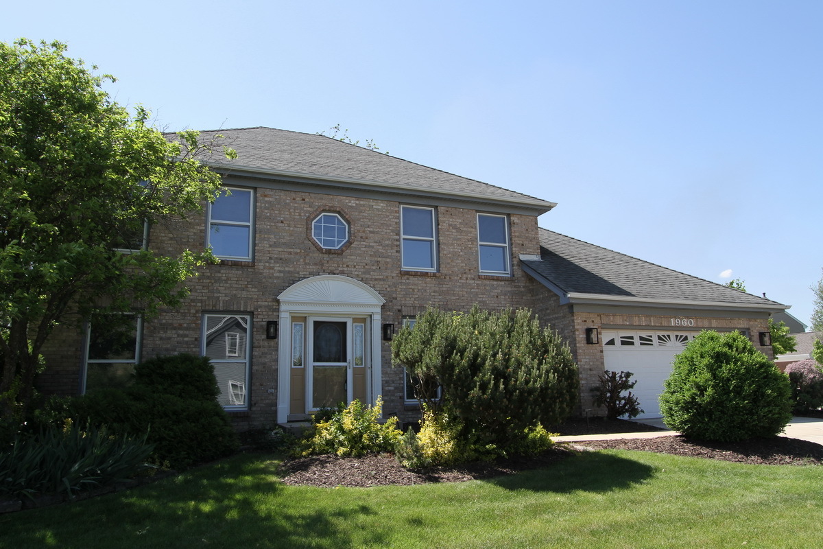 1960 Slippery Rock Road Naperville, IL 60565 - Photo 1 of 22 a front view of a house with a yard