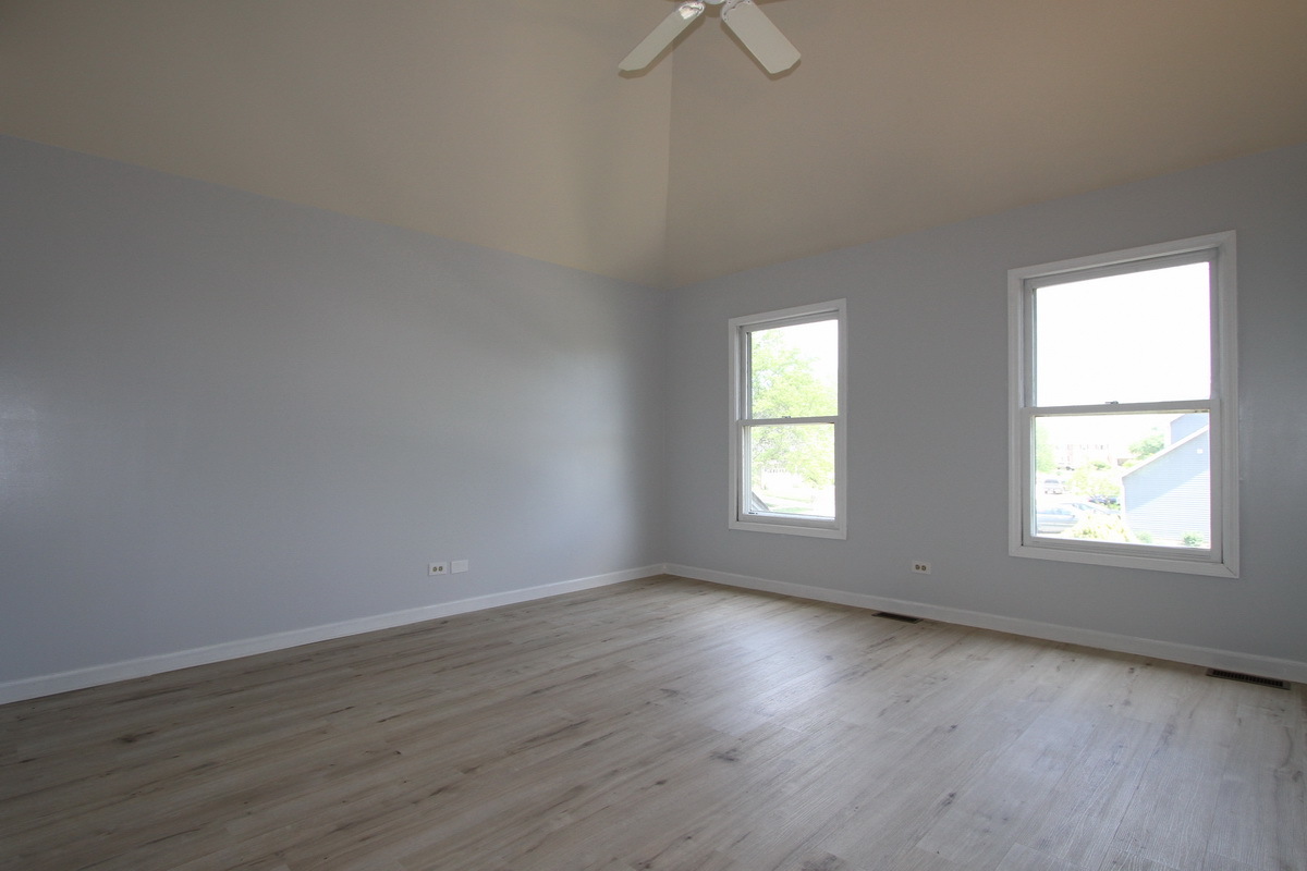1960 Slippery Rock Road Naperville, IL 60565 - Photo 11 of 22 an empty room with wooden floor and windows