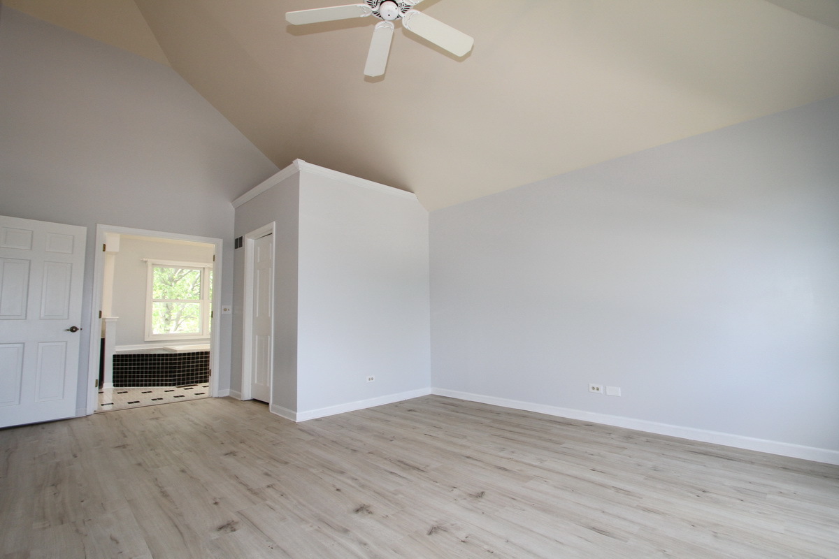1960 Slippery Rock Road Naperville, IL 60565 - Photo 12 of 22 a view of a room with wooden floor and ceiling fan