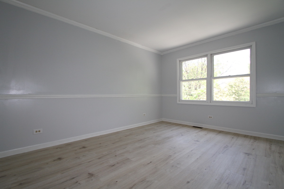 1960 Slippery Rock Road Naperville, IL 60565 - Photo 15 of 22 an empty room with wooden floor and windows