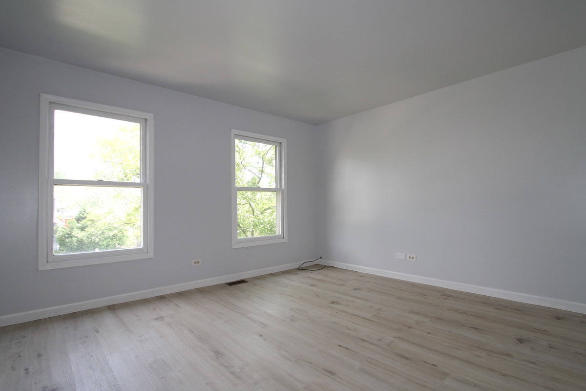1960 Slippery Rock Road Naperville, IL 60565 - Photo 17 of 22 an empty room with wooden floor and windows