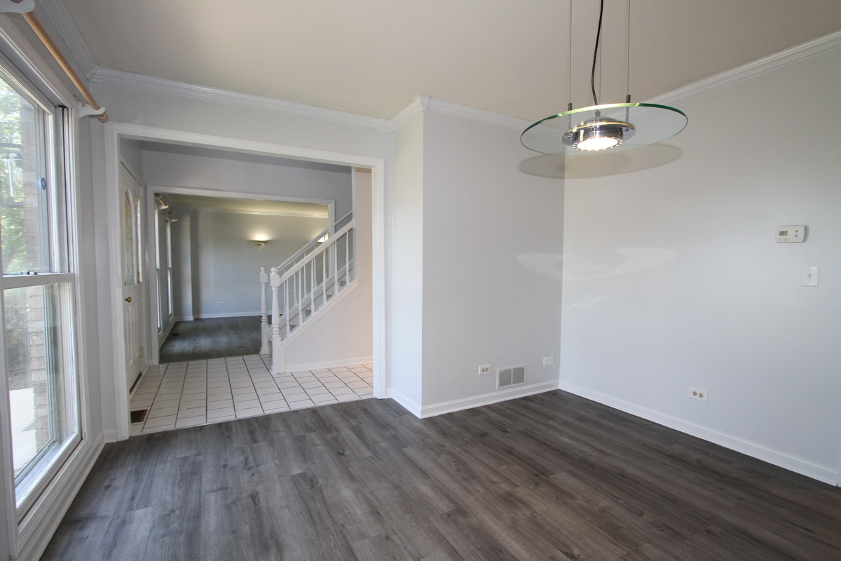 1960 Slippery Rock Road Naperville, IL 60565 - Photo 4 of 22 a view of a room with wooden floor staircase and a kitchen