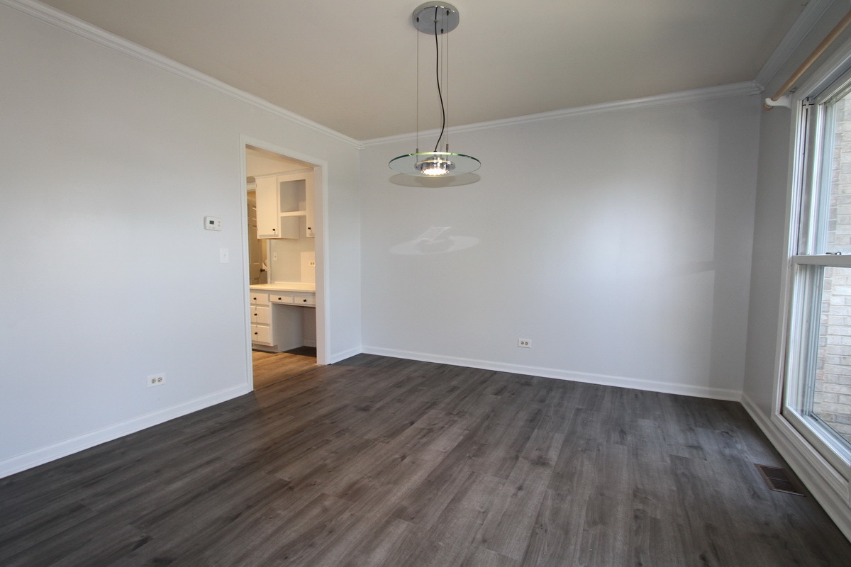 1960 Slippery Rock Road Naperville, IL 60565 - Photo 5 of 22 an empty room with wooden floor and windows