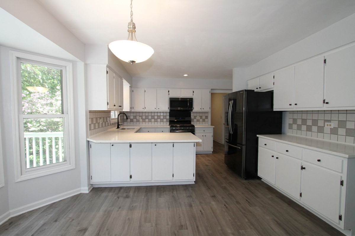 1960 Slippery Rock Road Naperville, IL 60565 - Photo 8 of 22 a kitchen with stainless steel appliances granite countertop a refrigerator a sink dishwasher a stove and white cabinets with wooden floor
