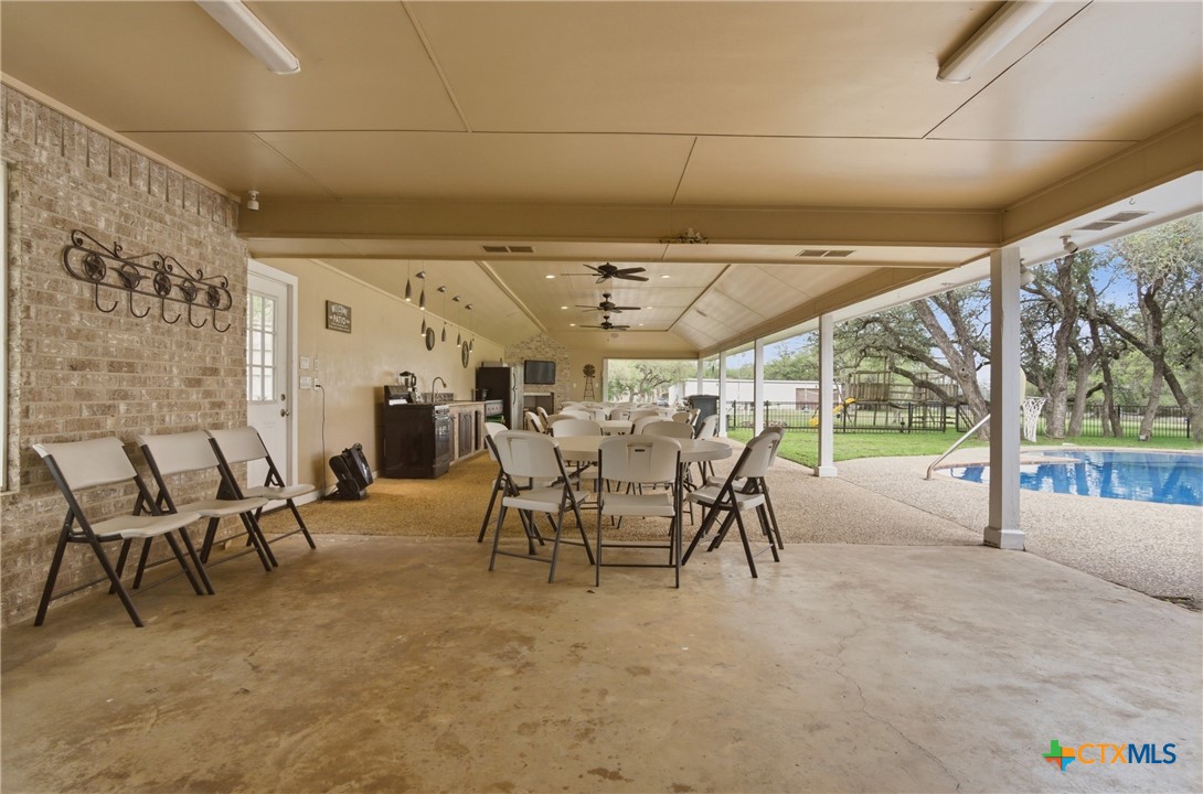 642 Phantom Rider Trail Spring Branch, TX 78070 - Photo 22 of 41 a view of a patio with table and chairs