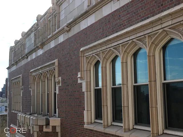 a front view of a multi story building with yard