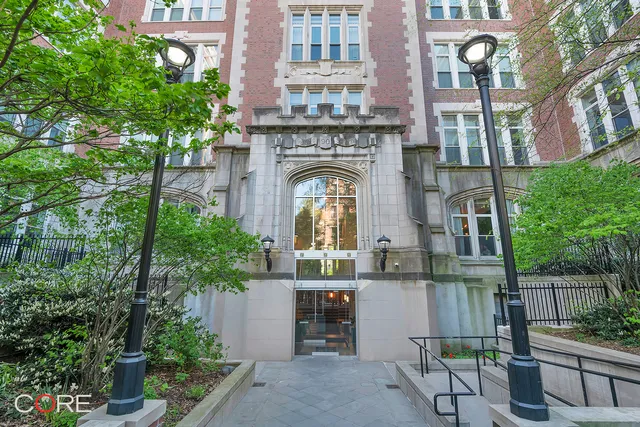 a view of a hallway with stairs and wooden floor