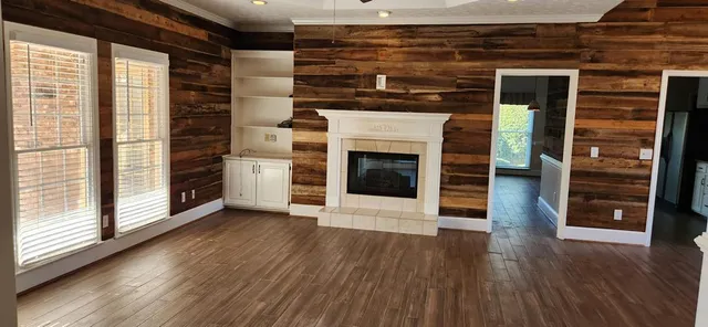 wooden floor in an empty room with a fireplace