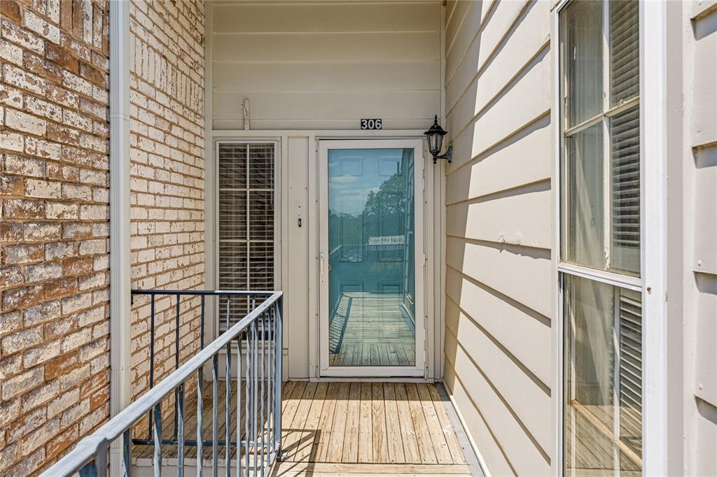 2903 Lake Shore Drive, Unit 306 Waco, TX 76708 - Photo 1 of 1 a view of a balcony with wooden floor and iron fence