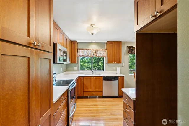 a kitchen with stainless steel appliances granite countertop a refrigerator and a stove