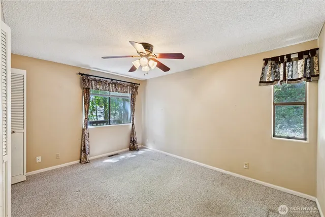 a view of room with window and ceiling fan