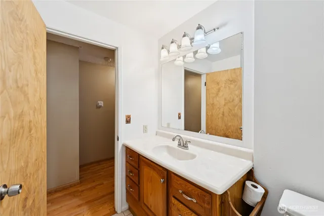 a bathroom with a sink vanity and mirror