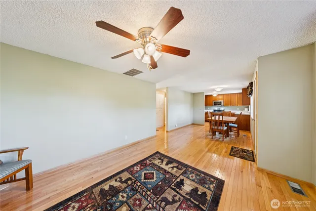 a view of a room with wooden floor and cabinetry