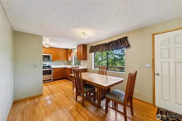 a dining room with furniture and wooden floor
