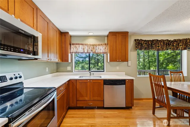 a kitchen with a stove a sink and a microwave