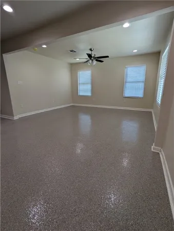 an empty room with windows and closet