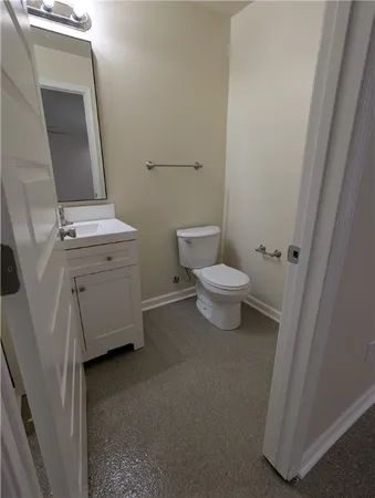 a bathroom with a toilet sink and a mirror