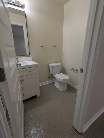 a bathroom with a toilet sink and a mirror