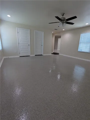 an empty room with closet and windows