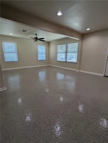 an empty room with windows and closet