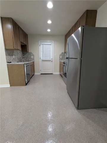 a kitchen with a refrigerator and cabinets