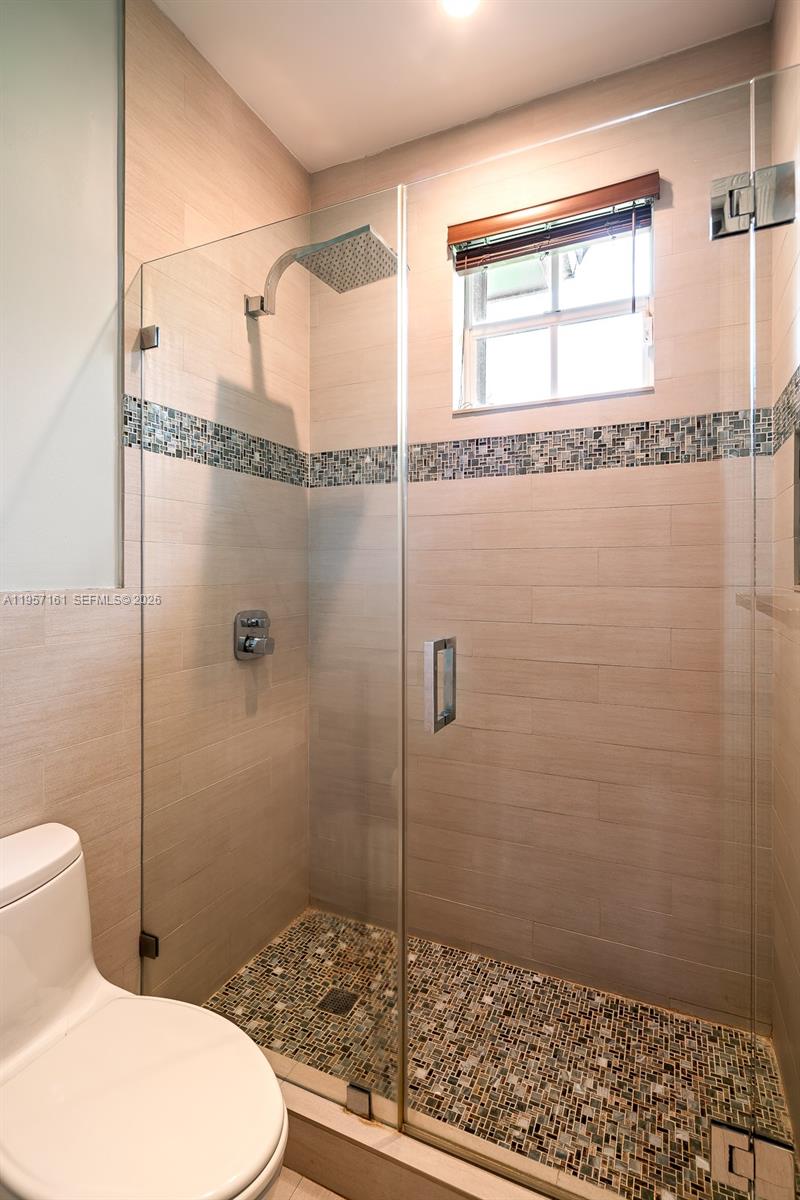 5770 Southwest 128th Street Pinecrest, FL 33156 - Photo 28 of 37 a bathroom with a toilet and a shower