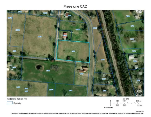 a view of a backyard with wooden fence and a small barn