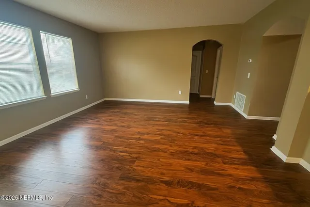 a view of room with window and wooden floor
