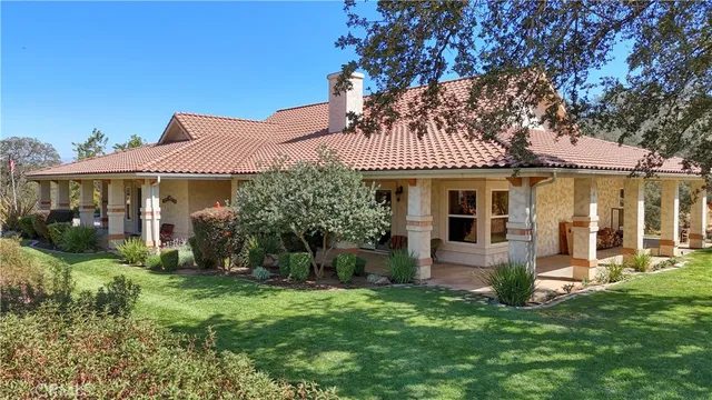 a front view of a house with a yard table and chairs