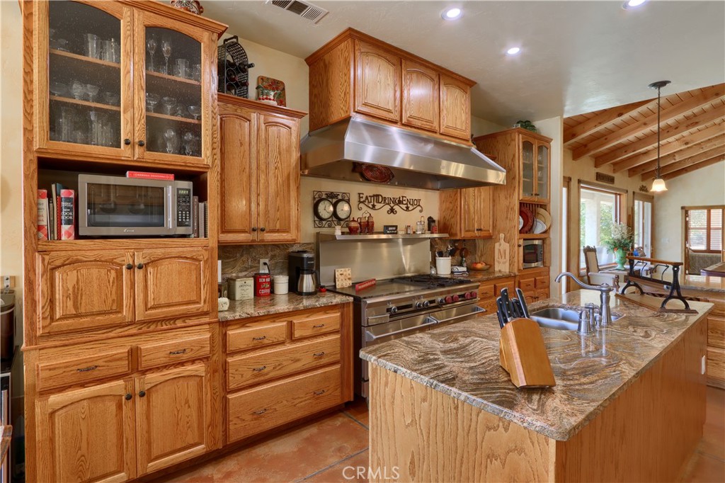 1087 Ben Hur Road Raymond, CA 93653 - Photo 19 of 75 a kitchen with stainless steel appliances granite countertop a sink and a refrigerator