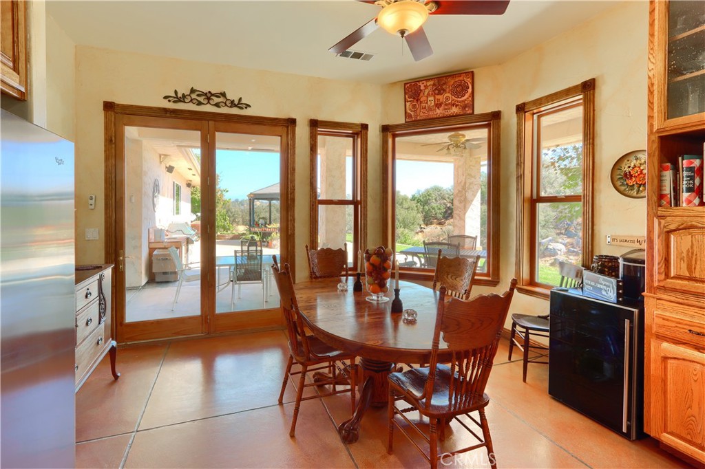 1087 Ben Hur Road Raymond, CA 93653 - Photo 22 of 75 a dining room with furniture a chandelier and wooden floor