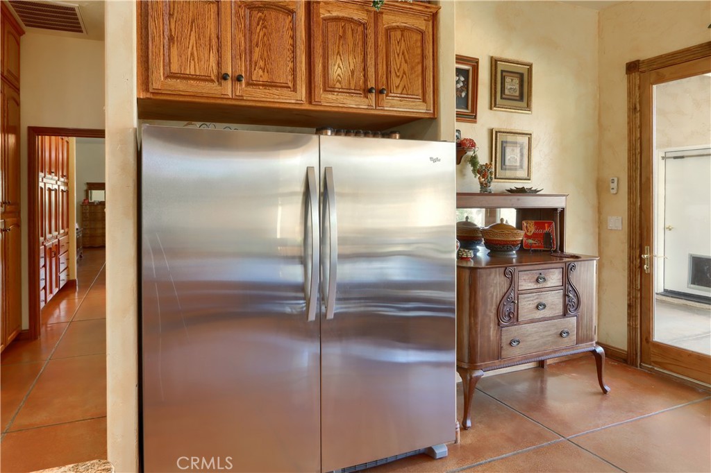 1087 Ben Hur Road Raymond, CA 93653 - Photo 23 of 75 a kitchen with stainless steel appliances refrigerator and cabinets