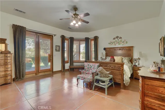 a bed sitting in a bedroom and a large mirror